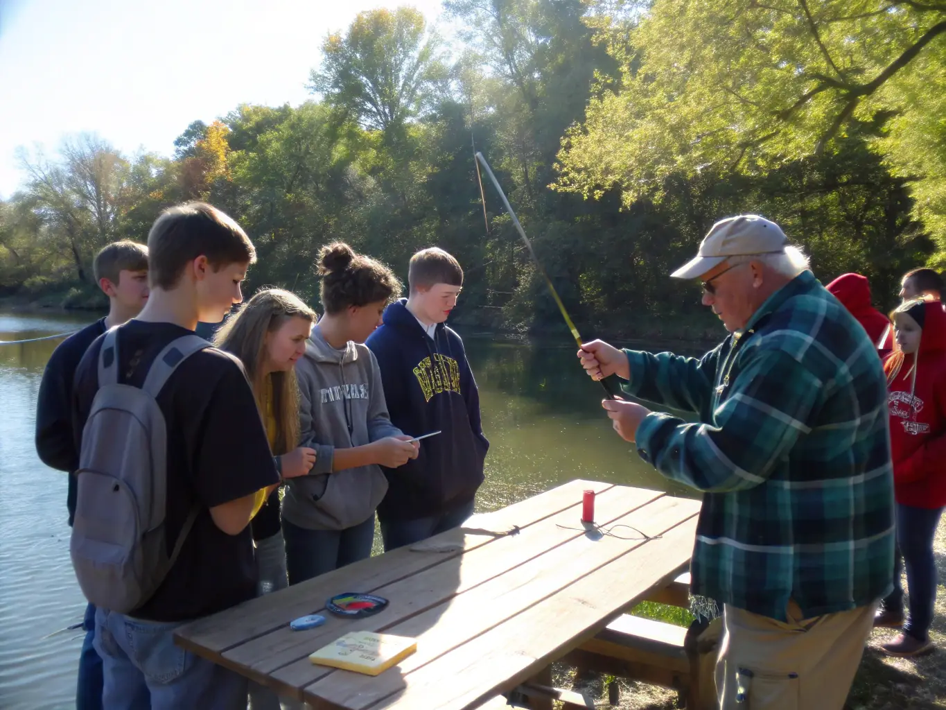An image depicting an educational workshop on responsible angling practices, showing instructors teaching participants about catch-and-release techniques and the importance of protecting aquatic resources. The scene should be engaging and informative.